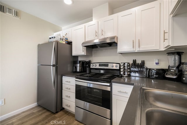 kitchen with sink, dark hardwood / wood-style flooring, white cabinets, and appliances with stainless steel finishes