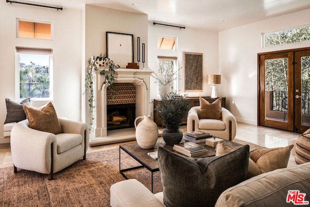 living area featuring tile patterned floors and french doors