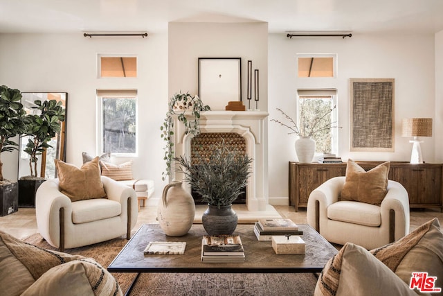 living area featuring a healthy amount of sunlight and a high end fireplace