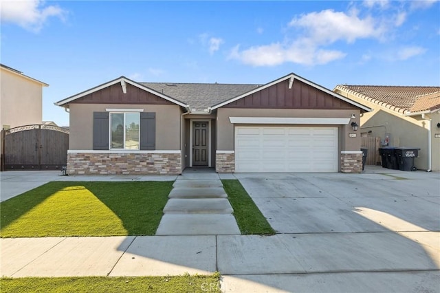 craftsman-style house featuring a front yard and a garage