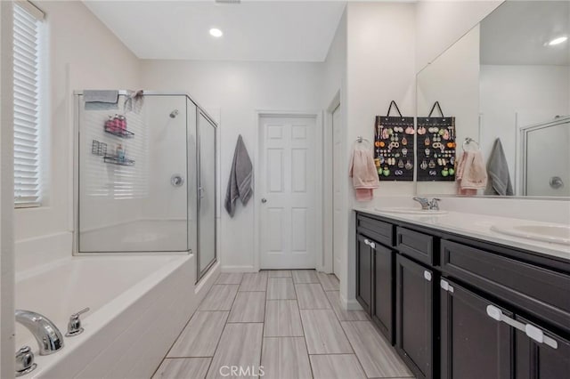 bathroom with vanity and independent shower and bath