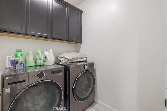 laundry room featuring cabinets and independent washer and dryer