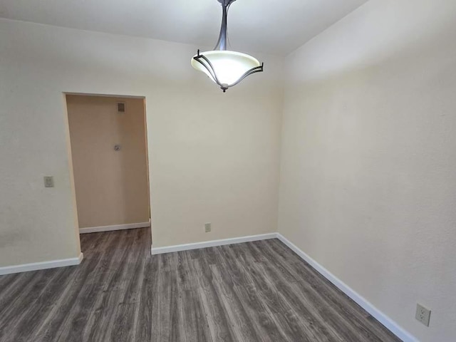 unfurnished dining area featuring dark wood-type flooring