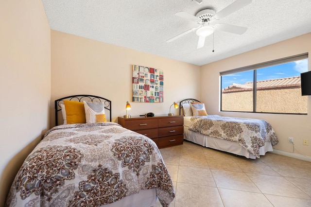 bedroom with a textured ceiling, ceiling fan, and light tile patterned floors