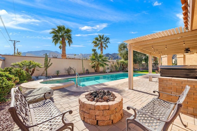 view of pool with an outdoor fire pit, an in ground hot tub, a patio, a mountain view, and a pergola