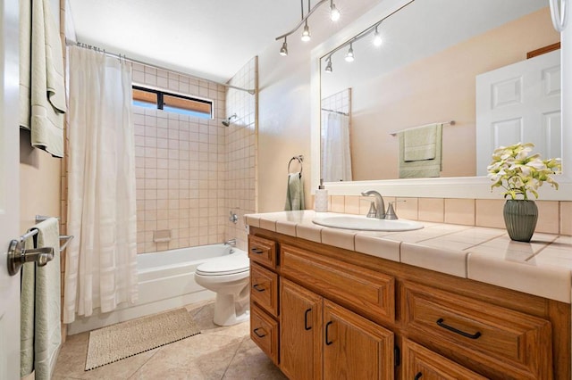 full bathroom featuring toilet, shower / bath combo with shower curtain, tile patterned floors, and vanity