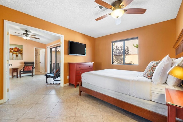 tiled bedroom with ceiling fan, lofted ceiling, and a textured ceiling