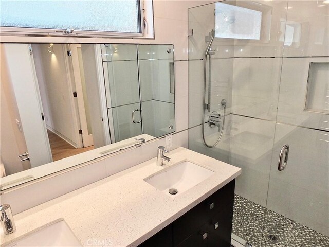 bathroom with an enclosed shower and vanity