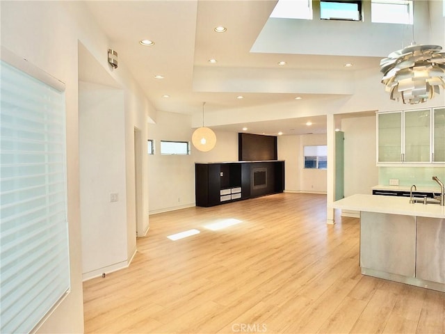 kitchen featuring pendant lighting, sink, and light wood-type flooring