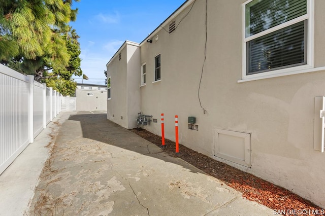 view of property exterior with a patio area