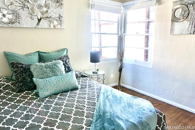 bedroom with hardwood / wood-style flooring