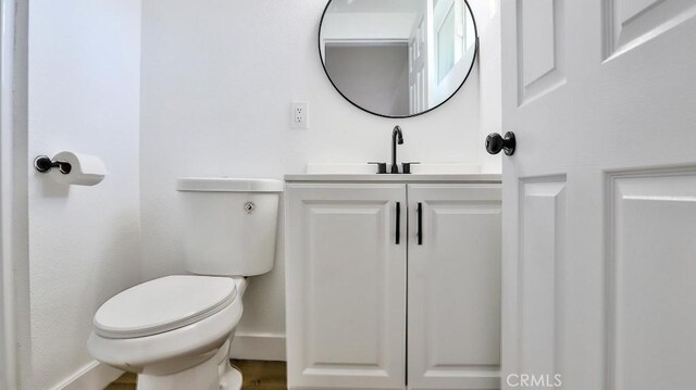 bathroom featuring toilet and vanity