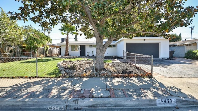 view of front of home featuring a garage and a front lawn