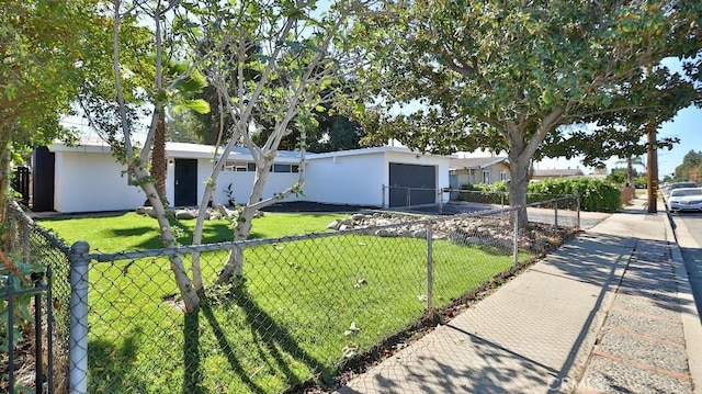 ranch-style home featuring a garage and a front lawn