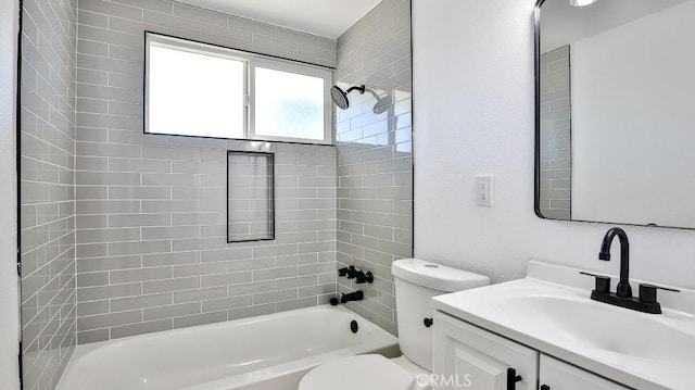 full bathroom featuring vanity, toilet, and tiled shower / bath