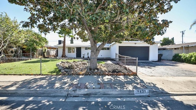 view of front of home featuring a garage and a front lawn