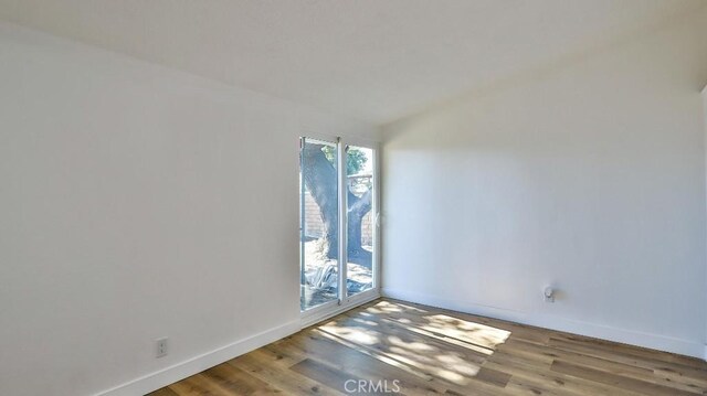 spare room with hardwood / wood-style flooring