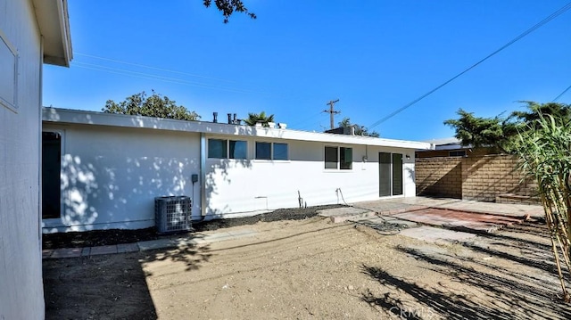 back of house featuring cooling unit and a patio area