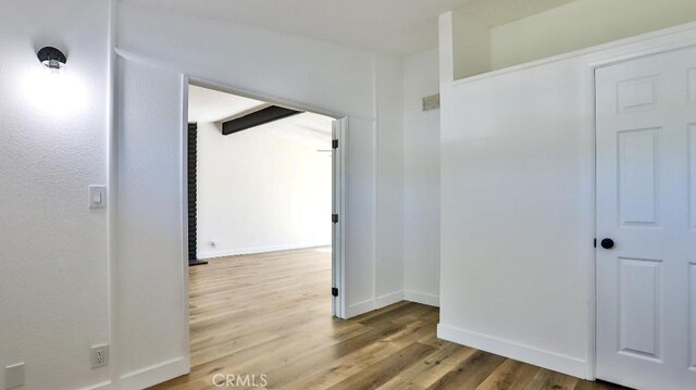 hallway with wood-type flooring