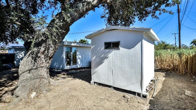 view of home's exterior featuring a storage unit