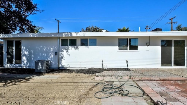 view of front of house featuring central AC unit and a patio