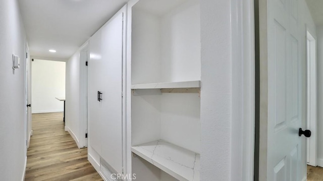 hall with light hardwood / wood-style flooring