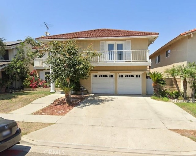 view of front of house featuring a balcony and a garage