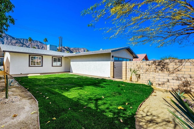 rear view of property with a yard