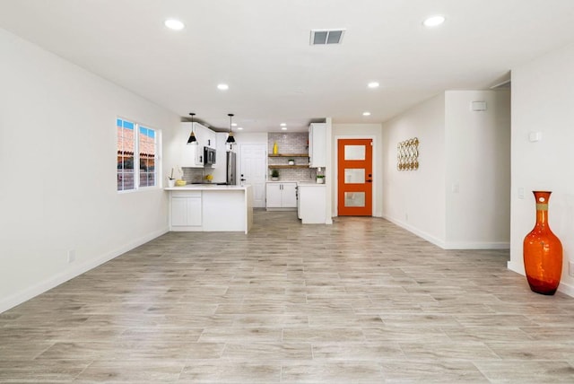 unfurnished living room featuring light wood-type flooring