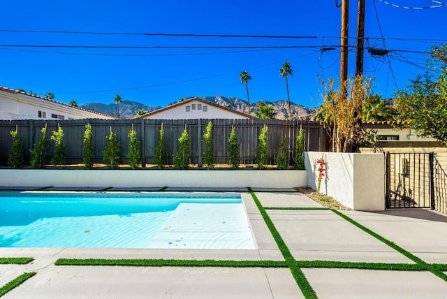 view of swimming pool featuring a mountain view and a patio