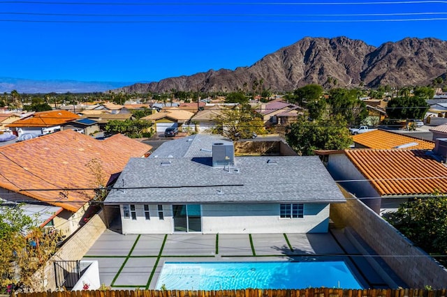 exterior space featuring a mountain view and a patio area