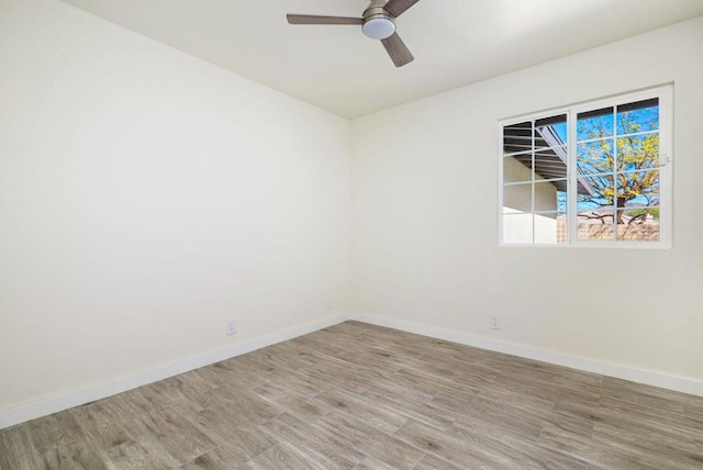 spare room featuring hardwood / wood-style floors and ceiling fan