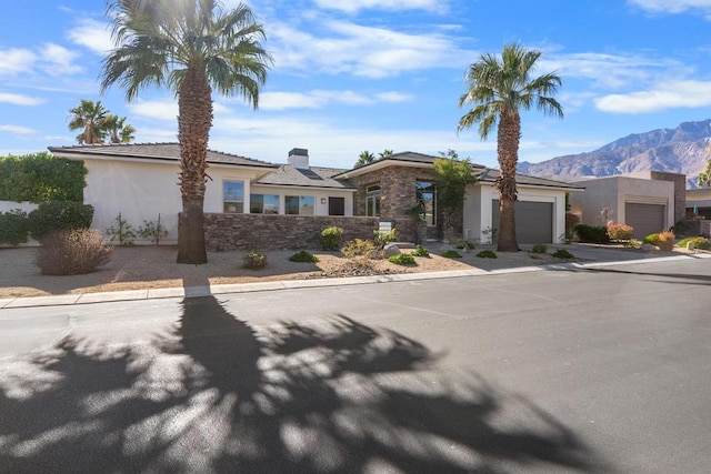 view of front of home featuring a mountain view and a garage