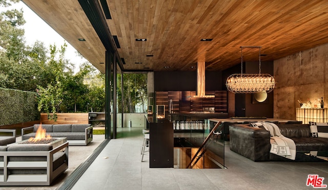 view of patio featuring an outdoor living space with a fire pit