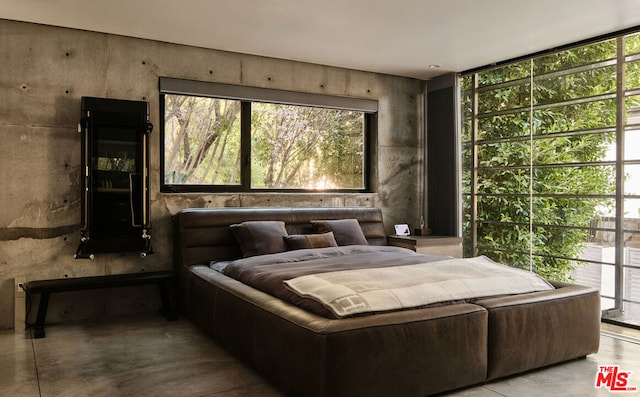 bedroom featuring concrete flooring