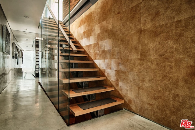 stairs featuring concrete floors