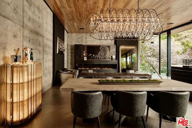 interior space featuring a chandelier, a wall of windows, a fireplace, and wood ceiling