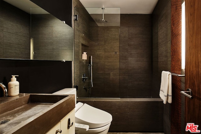 bathroom with vanity, toilet, and tiled shower