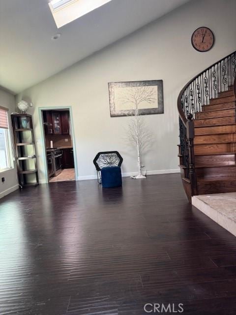 unfurnished room featuring dark hardwood / wood-style floors and lofted ceiling with skylight