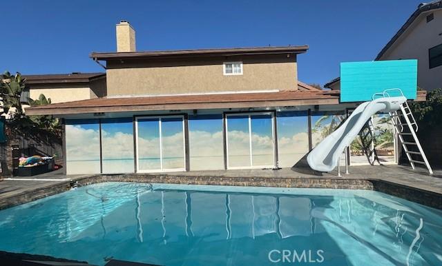 view of pool featuring a water slide