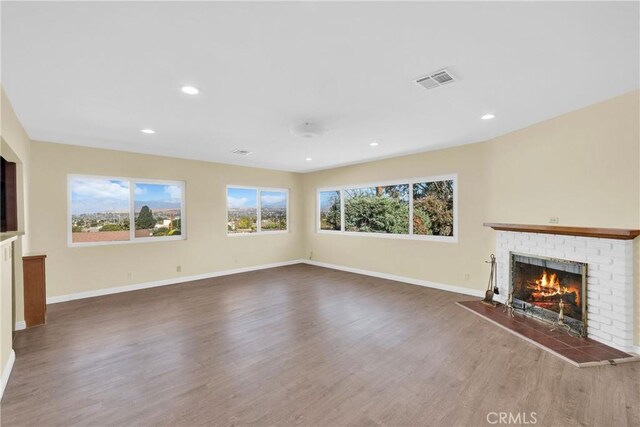 unfurnished living room featuring a fireplace and hardwood / wood-style flooring