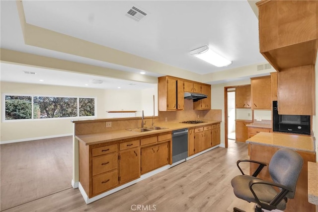 kitchen featuring sink, dishwasher, a kitchen breakfast bar, light hardwood / wood-style flooring, and gas stovetop