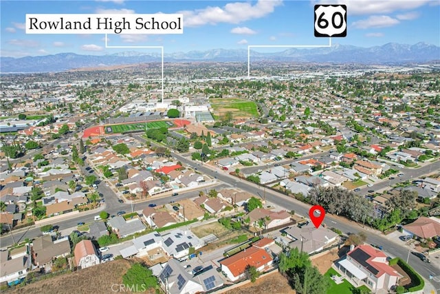 birds eye view of property with a mountain view