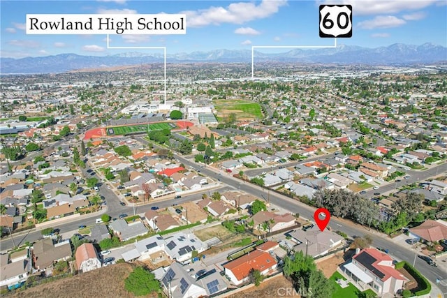 drone / aerial view featuring a residential view and a mountain view