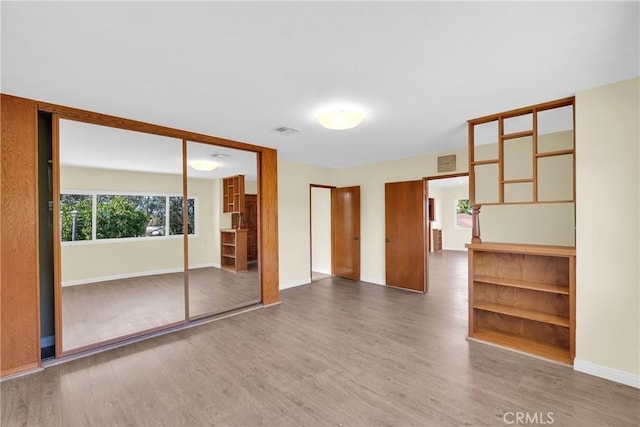 spare room featuring wood-type flooring