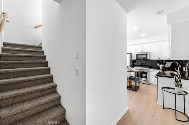 5550 Boardwalk Unit 102, Hawthorne, CA 90250 - stairs with wood finished floors and recessed lighting