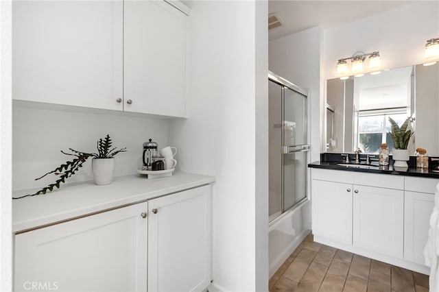 interior space featuring white cabinetry and sink