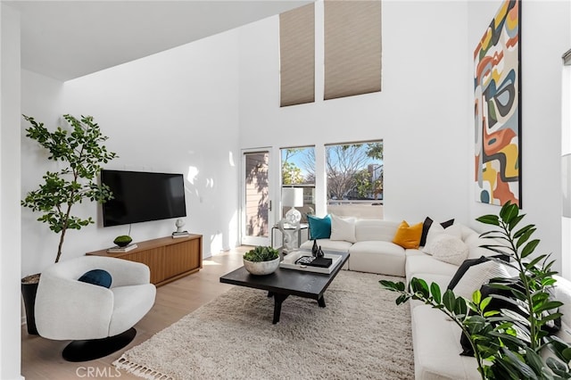 5550 Boardwalk Unit 102, Hawthorne, CA 90250 - living area featuring a high ceiling and wood finished floors