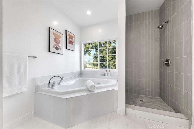 bathroom featuring tile patterned flooring and independent shower and bath