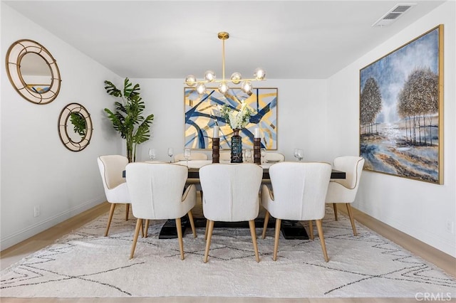 dining space featuring hardwood / wood-style floors and a chandelier